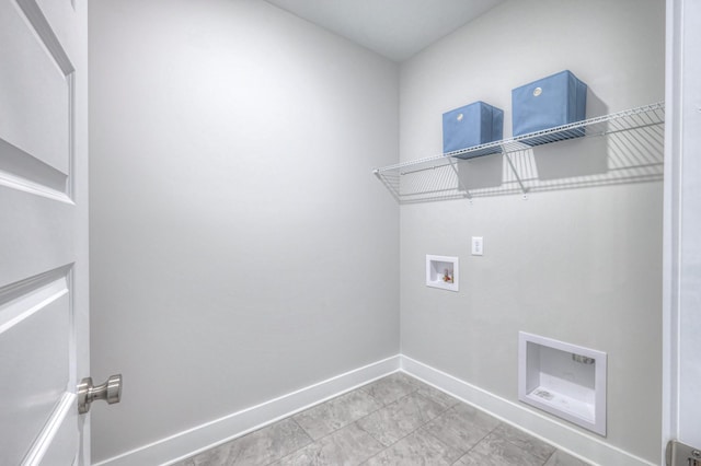 washroom featuring hookup for a washing machine, laundry area, and baseboards