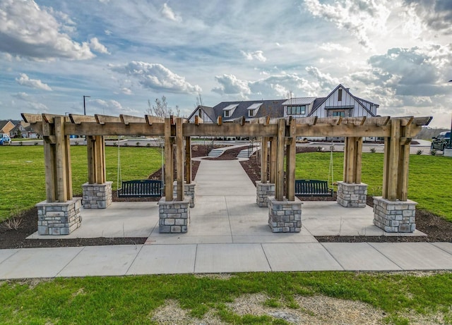 view of home's community with a yard and a pergola