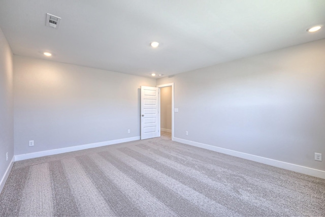 empty room with light carpet, baseboards, visible vents, and recessed lighting