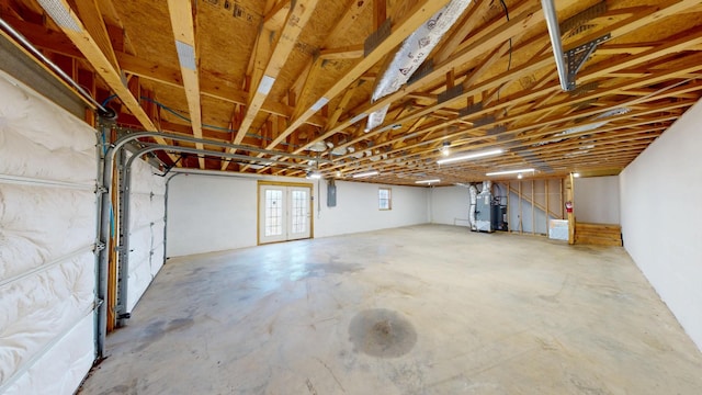 interior space with a garage, heating unit, and electric panel