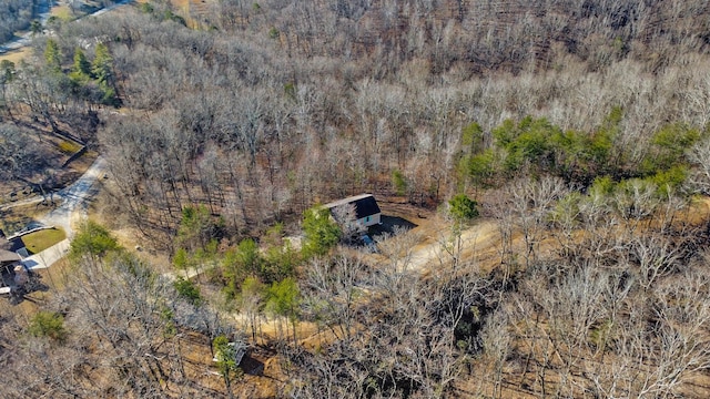 birds eye view of property featuring a wooded view