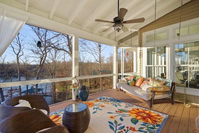 sunroom / solarium featuring lofted ceiling with beams and a ceiling fan