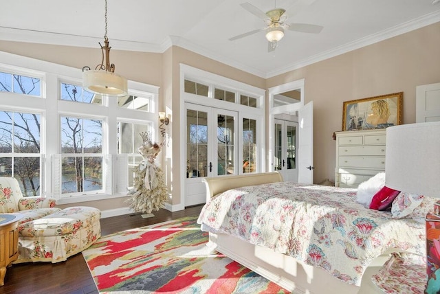 bedroom featuring baseboards, lofted ceiling, wood finished floors, crown molding, and french doors