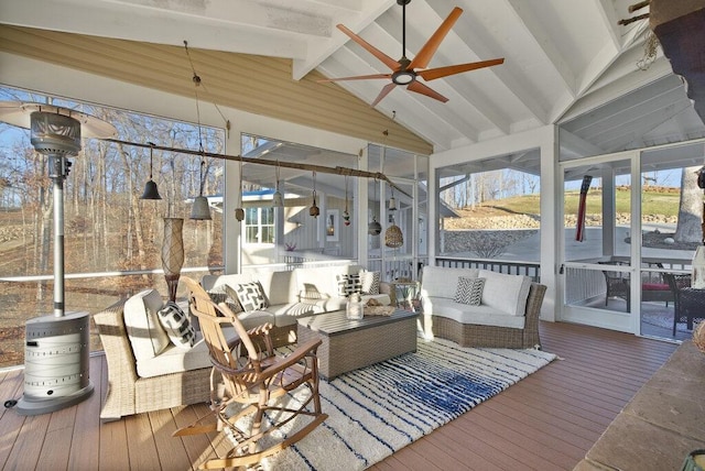sunroom featuring lofted ceiling with beams and ceiling fan