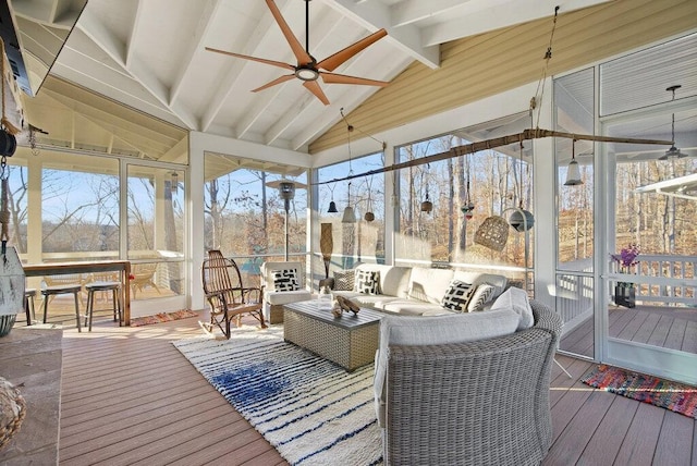 sunroom / solarium featuring a ceiling fan and vaulted ceiling with beams