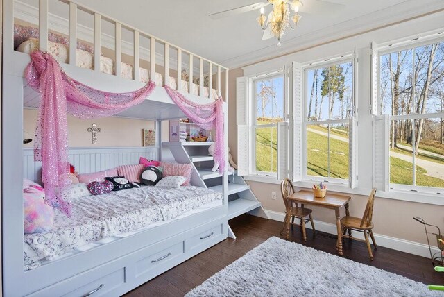 bedroom with baseboards, dark wood-style flooring, and crown molding