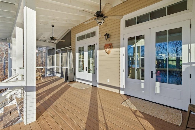 wooden deck with french doors and a ceiling fan