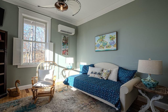 bedroom with ornamental molding, a wall mounted air conditioner, wood finished floors, and baseboards