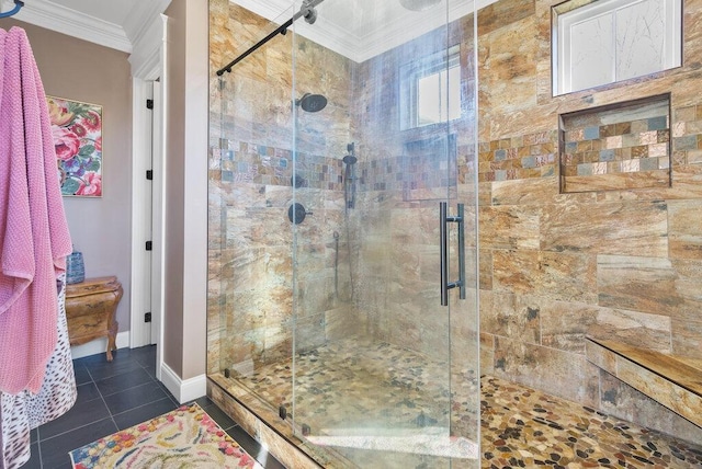 bathroom with a stall shower, tile patterned flooring, baseboards, and crown molding