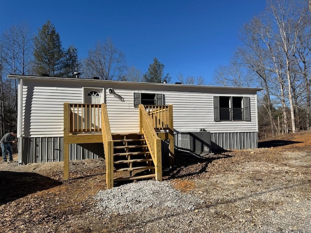 manufactured / mobile home featuring stairway and a wooden deck