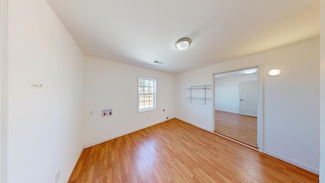 unfurnished bedroom with light wood-type flooring, visible vents, and baseboards