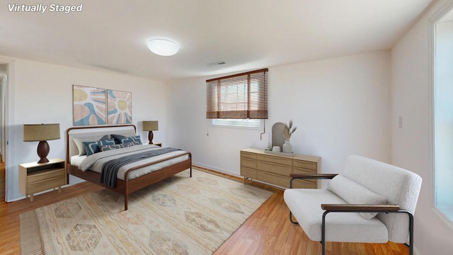 bedroom with light wood-type flooring and visible vents