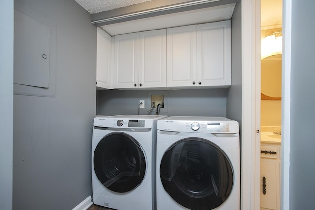 laundry area with cabinet space and separate washer and dryer