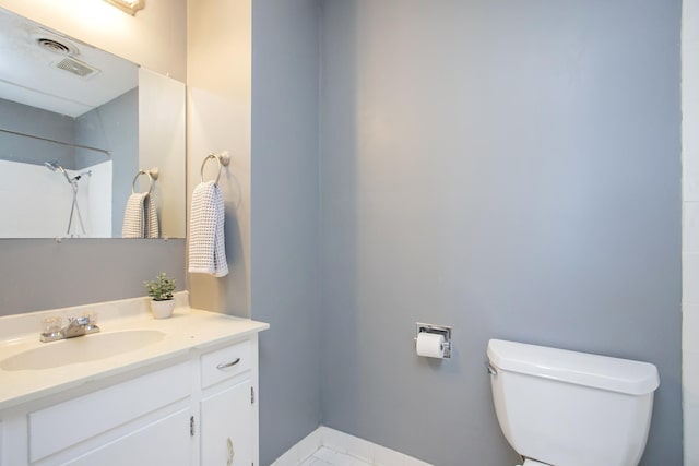 bathroom with toilet, walk in shower, and vanity