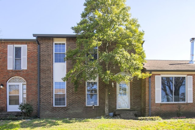 view of front of house featuring entry steps and brick siding