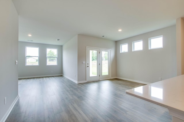 interior space featuring recessed lighting, wood finished floors, visible vents, and baseboards