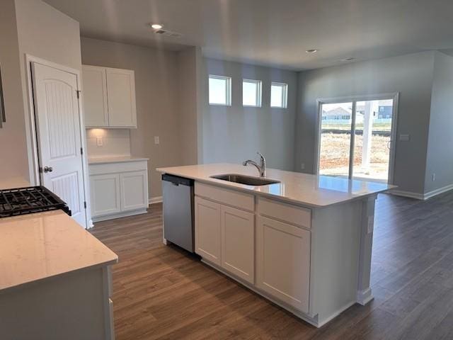 kitchen with dishwasher, a wealth of natural light, a sink, and white cabinetry