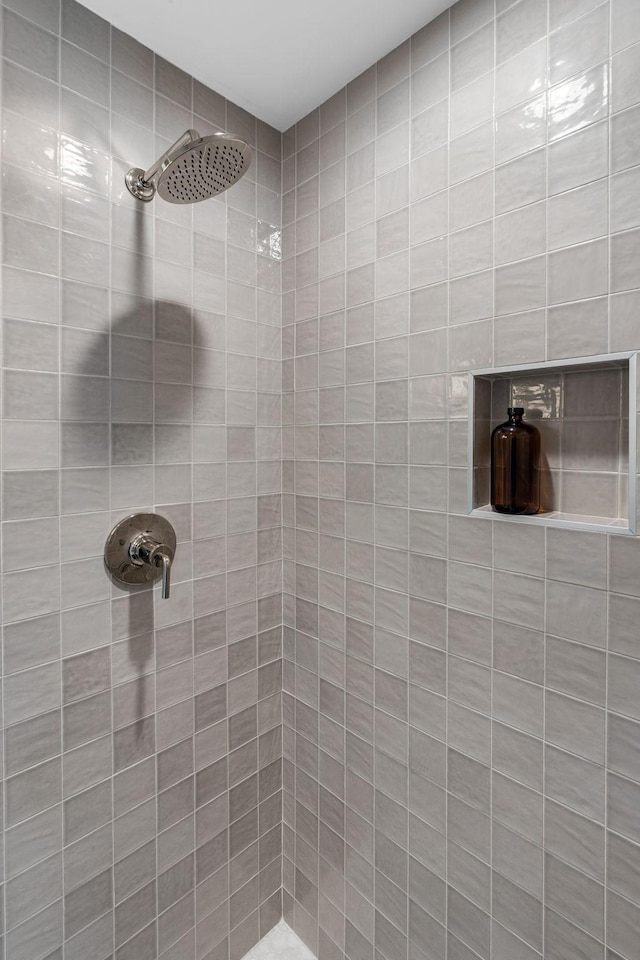 bathroom with tiled shower