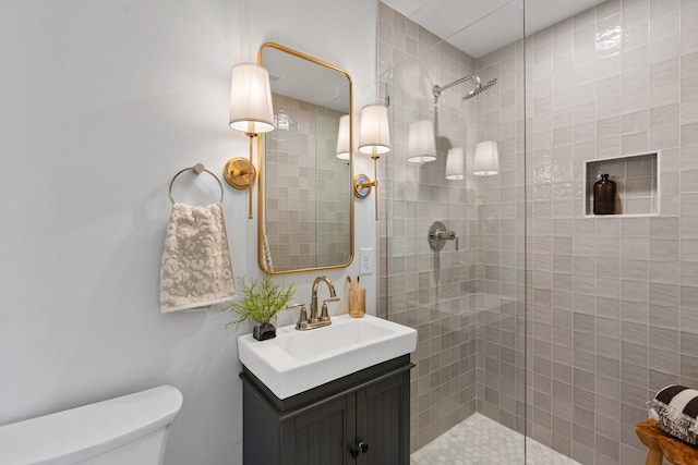 full bathroom featuring vanity, toilet, and walk in shower