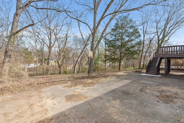 view of yard with stairway and a wooden deck