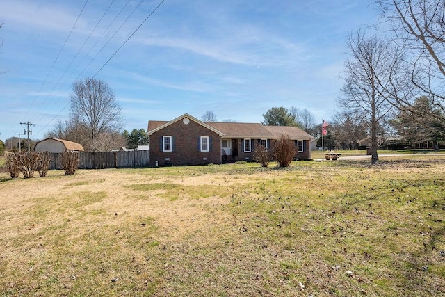 view of front of property featuring crawl space, fence, a front lawn, and brick siding