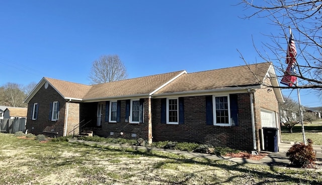 view of side of property featuring a yard, brick siding, roof with shingles, and an attached garage