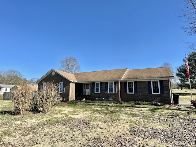 ranch-style house with a front yard, crawl space, and brick siding