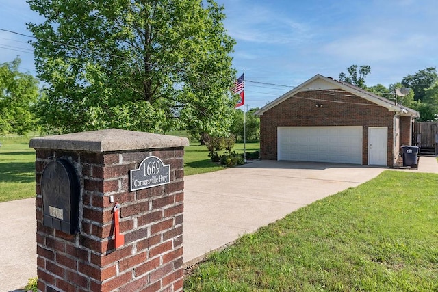 1669 Cornersville Hwy, Lewisburg, TN 37091 - exterior space with a lawn, brick siding, an outdoor structure, and a garage