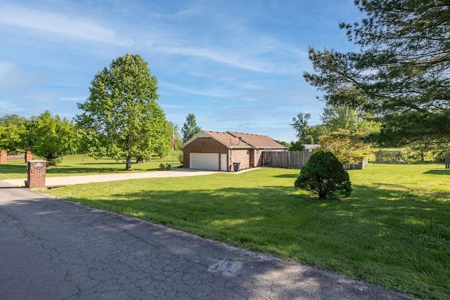 1669 Cornersville Hwy, Lewisburg, TN 37091 - view of front of home with a garage, fence, driveway, and a front lawn