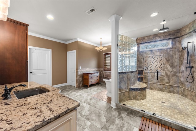 bathroom with visible vents, ornamental molding, tiled shower, and vanity