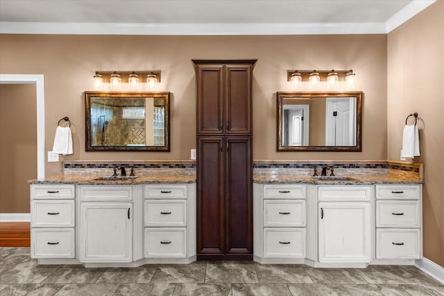 bathroom with tiled shower, two vanities, and a sink