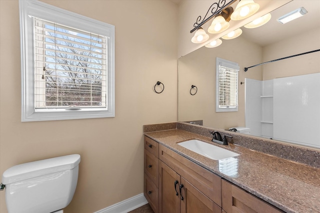 full bathroom with vanity, toilet, and baseboards