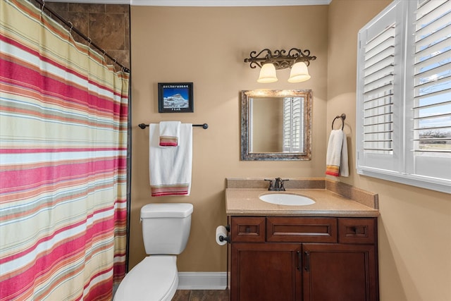 bathroom featuring a shower with shower curtain, vanity, toilet, and baseboards