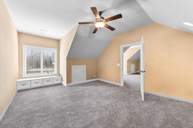 additional living space with vaulted ceiling, carpet floors, a ceiling fan, and baseboards