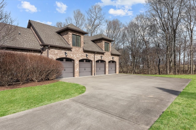 exterior space featuring driveway, a garage, roof with shingles, a front lawn, and brick siding