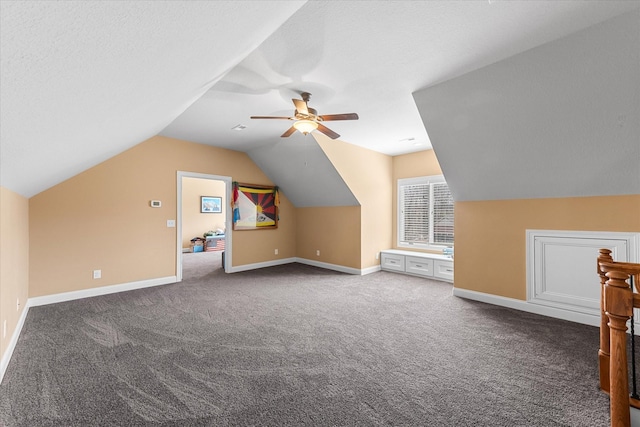 additional living space with carpet floors, a textured ceiling, baseboards, and a ceiling fan