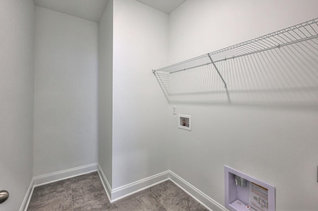 clothes washing area featuring laundry area, hookup for a washing machine, and baseboards