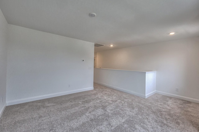 carpeted spare room with baseboards and recessed lighting