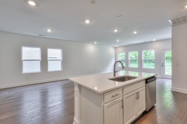 kitchen with dark wood finished floors, open floor plan, a sink, and stainless steel dishwasher