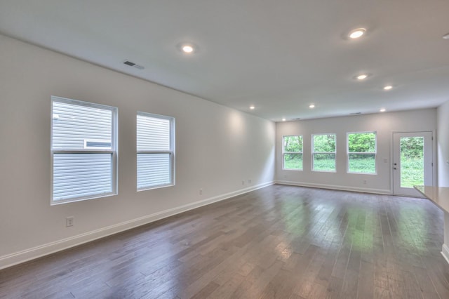 spare room featuring recessed lighting, visible vents, dark wood finished floors, and baseboards