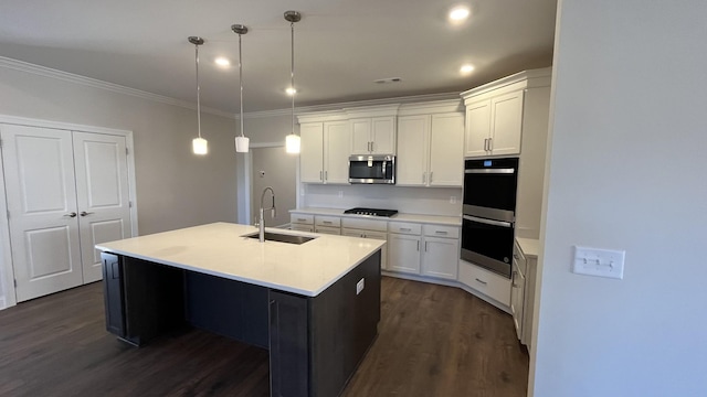 kitchen featuring a sink, stainless steel appliances, dark wood-type flooring, white cabinetry, and crown molding