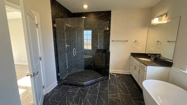 bathroom featuring marble look tile flooring, baseboards, vanity, a marble finish shower, and a soaking tub