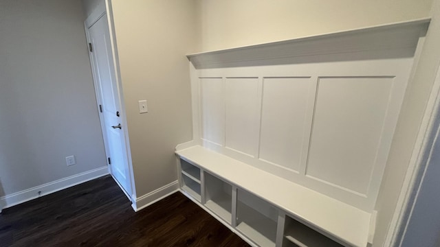 mudroom with dark wood-style floors and baseboards