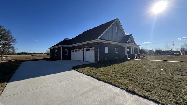 view of side of home featuring concrete driveway, brick siding, board and batten siding, and a lawn