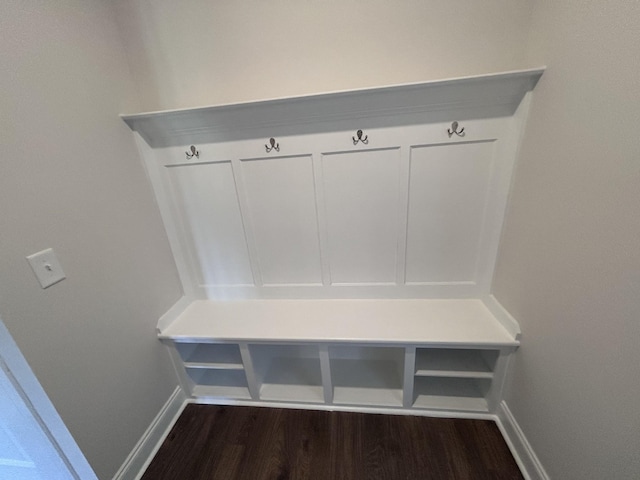 mudroom featuring baseboards and dark wood-style flooring
