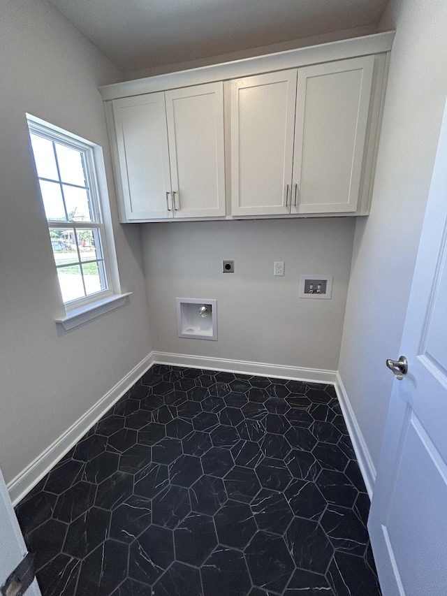 laundry area featuring electric dryer hookup, hookup for a washing machine, cabinet space, and baseboards