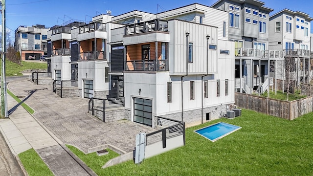 exterior space featuring a garage, a residential view, and central air condition unit