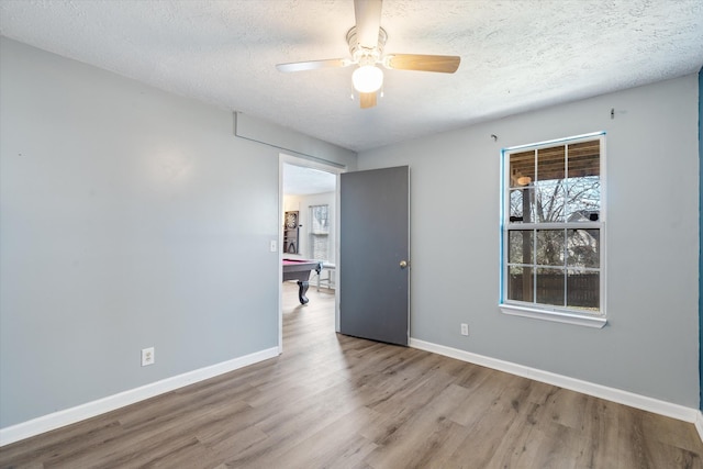 unfurnished room with pool table, wood finished floors, and baseboards