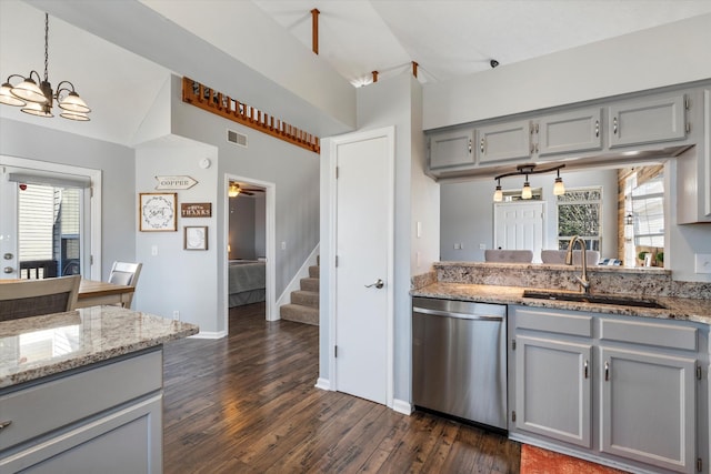 kitchen featuring a wealth of natural light, a sink, dishwasher, and gray cabinetry