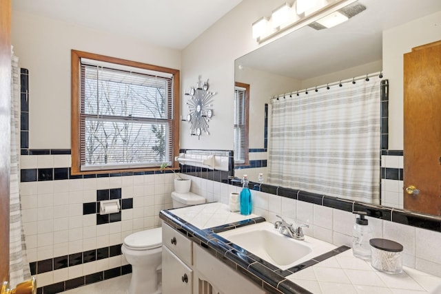 full bathroom with toilet, visible vents, vanity, tile walls, and a shower with curtain